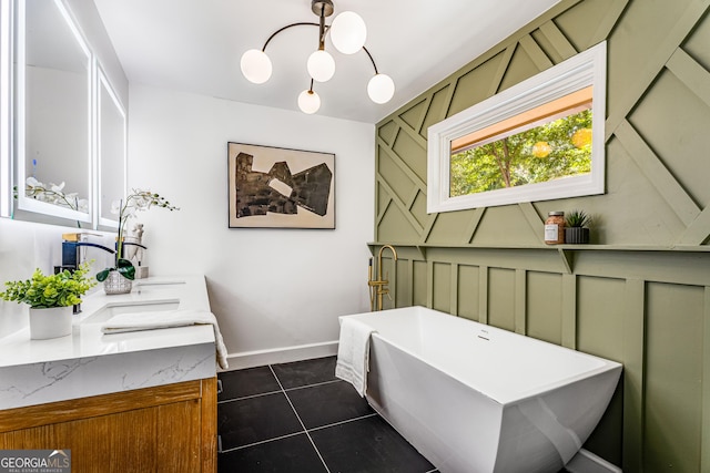 bathroom with a bathing tub, tile patterned flooring, vanity, and a chandelier