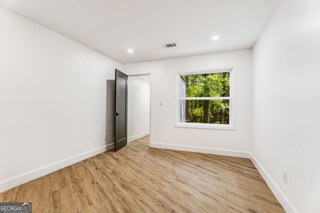 unfurnished bedroom with light wood-type flooring