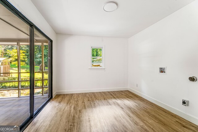 unfurnished room with hardwood / wood-style flooring