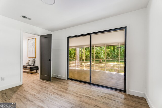 spare room with light hardwood / wood-style flooring