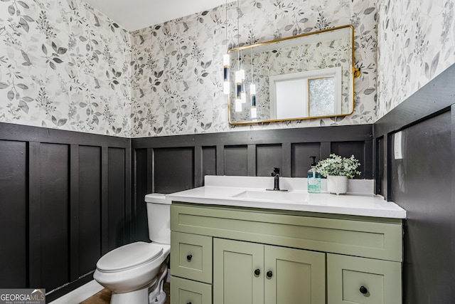 bathroom featuring vanity and toilet