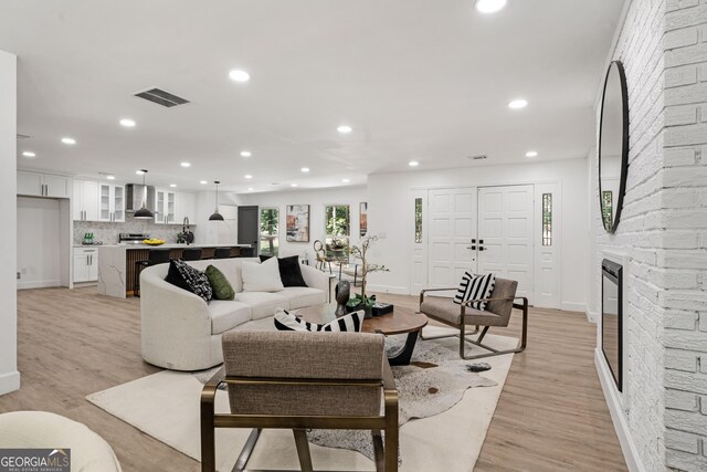 living room with a fireplace and light hardwood / wood-style flooring