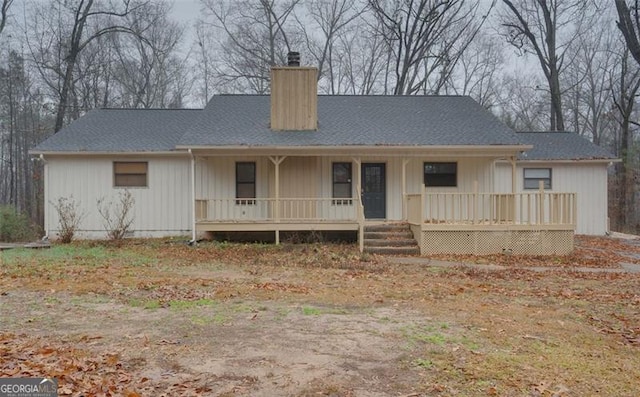 back of property with a porch