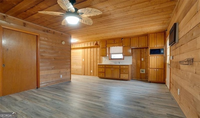 kitchen featuring wood-type flooring, wooden ceiling, and black microwave