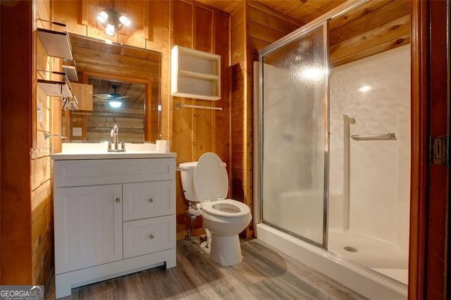 bathroom featuring vanity, wood walls, an enclosed shower, and wood-type flooring