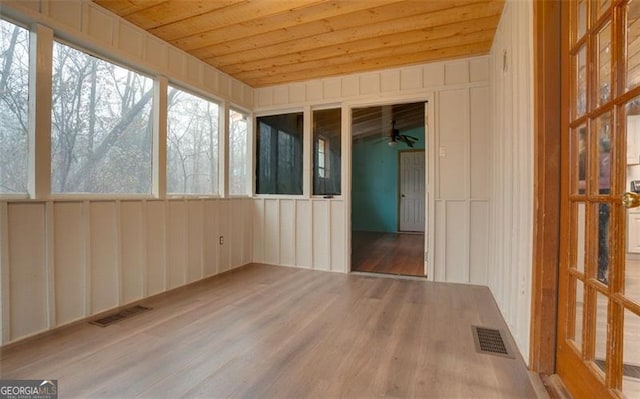 unfurnished sunroom with wooden ceiling