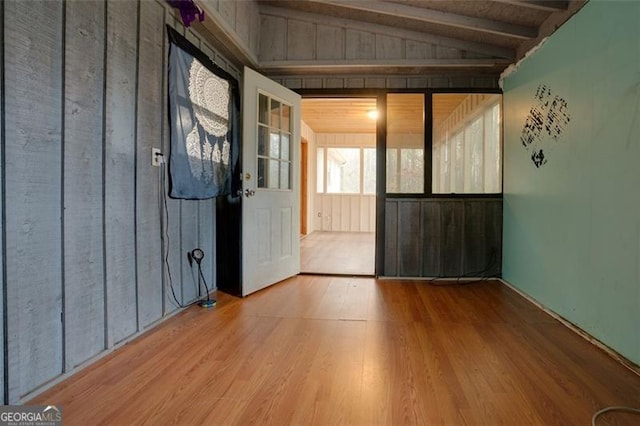 interior space with hardwood / wood-style floors and vaulted ceiling