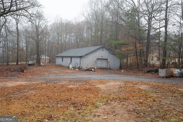 view of side of property with an outdoor structure and a garage