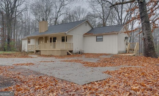 rear view of house featuring a porch