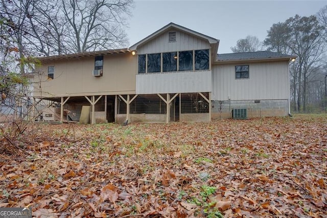 rear view of property with a sunroom and central AC unit