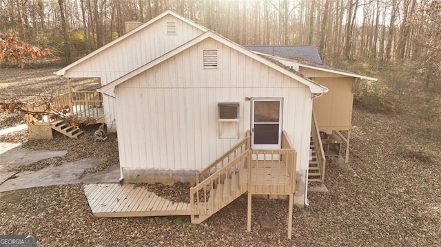 back of property featuring a wooden deck