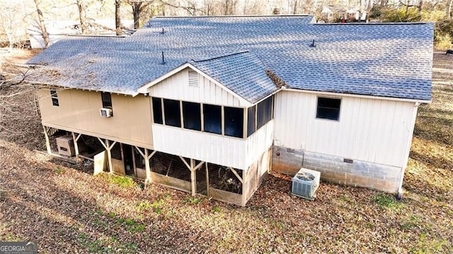 rear view of house featuring central AC