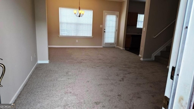 interior space with a notable chandelier and carpet floors