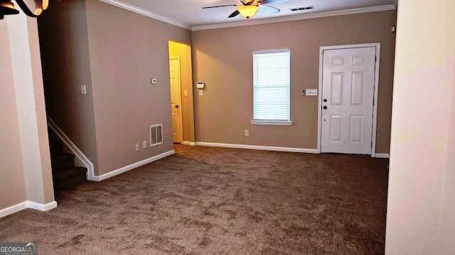 carpeted entryway featuring ceiling fan and crown molding