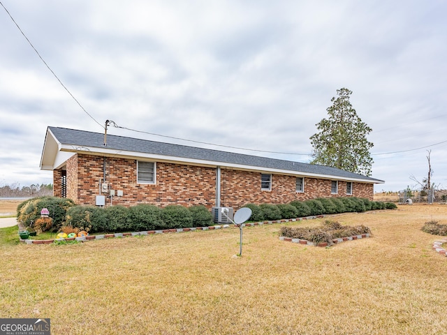 view of side of home with a yard