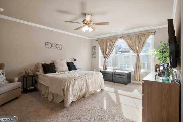 carpeted bedroom featuring ceiling fan and ornamental molding