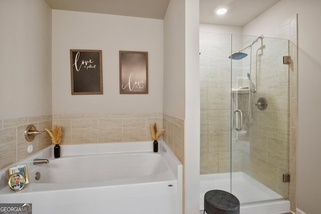 bathroom with shower with separate bathtub