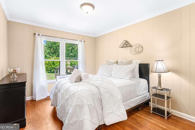 bedroom with crown molding and wood-type flooring