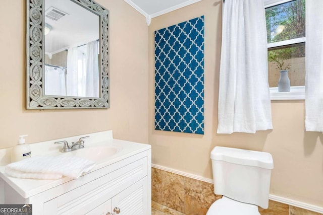 bathroom featuring vanity, toilet, and ornamental molding