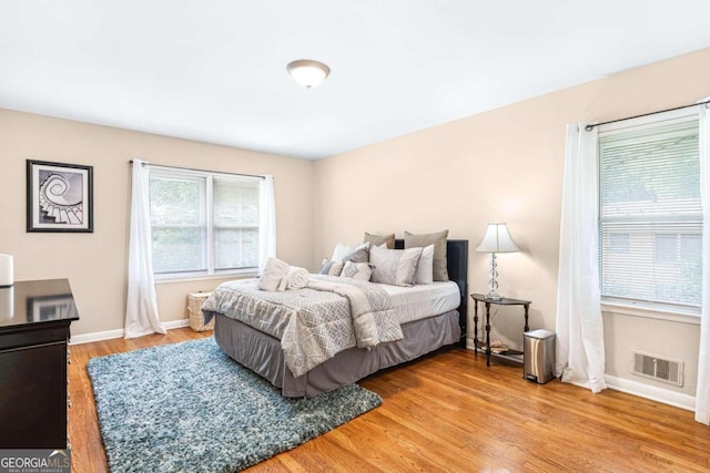 bedroom with hardwood / wood-style flooring