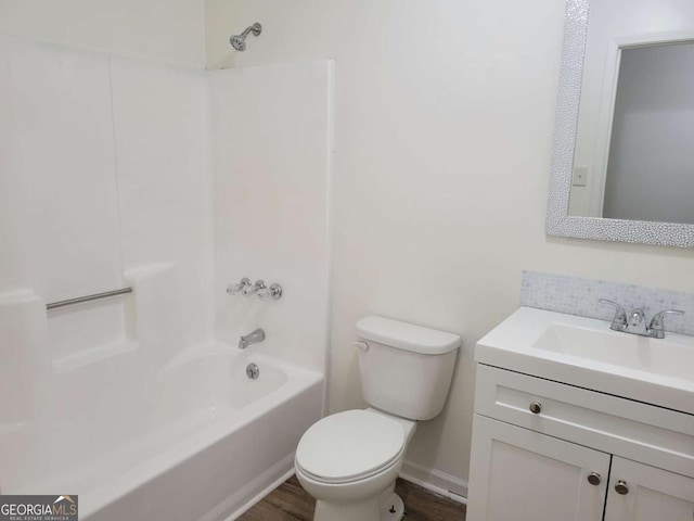 full bathroom with shower / bathing tub combination, vanity, toilet, and hardwood / wood-style flooring