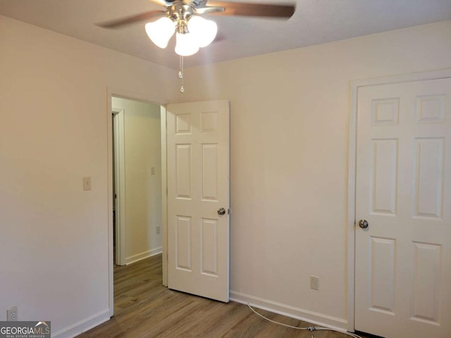 unfurnished bedroom with ceiling fan and light hardwood / wood-style floors