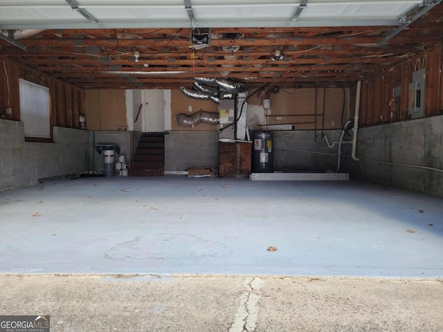 garage featuring electric panel, a garage door opener, and water heater