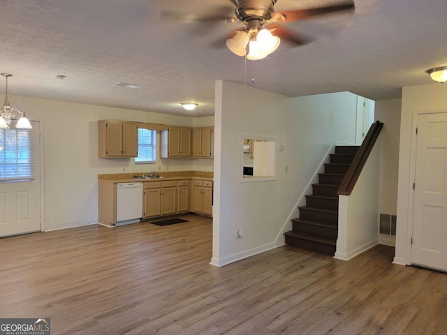 kitchen with pendant lighting, dishwasher, ceiling fan with notable chandelier, light brown cabinetry, and light hardwood / wood-style floors