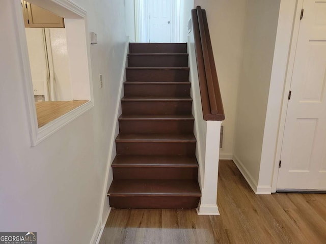 staircase featuring wood-type flooring