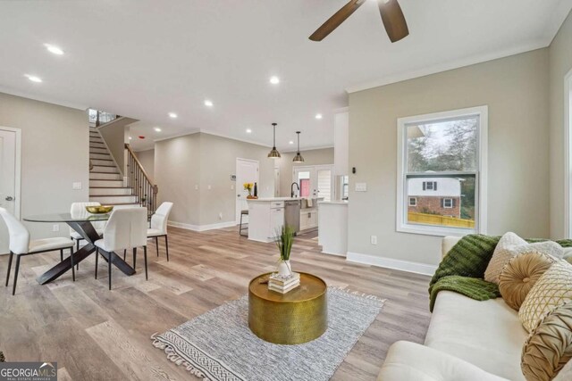 living room featuring ceiling fan and light hardwood / wood-style floors