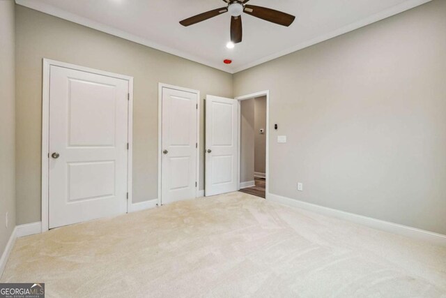 unfurnished bedroom with ceiling fan and carpet