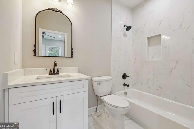 full bathroom with vanity, tiled shower / bath combo, and toilet