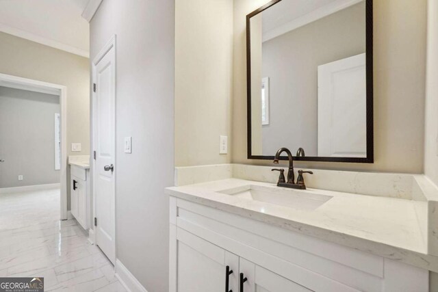 bathroom with vanity and ornamental molding