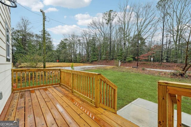 wooden deck with a lawn