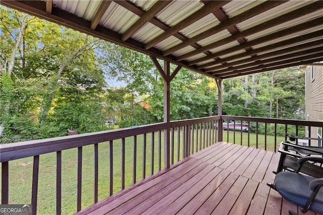 wooden terrace featuring a yard