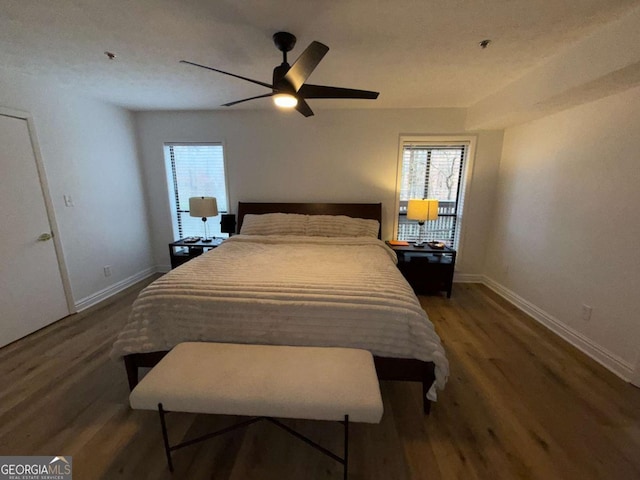 bedroom featuring ceiling fan and dark wood-type flooring