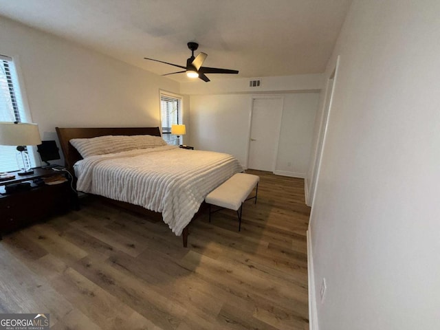 bedroom featuring ceiling fan and dark wood-type flooring