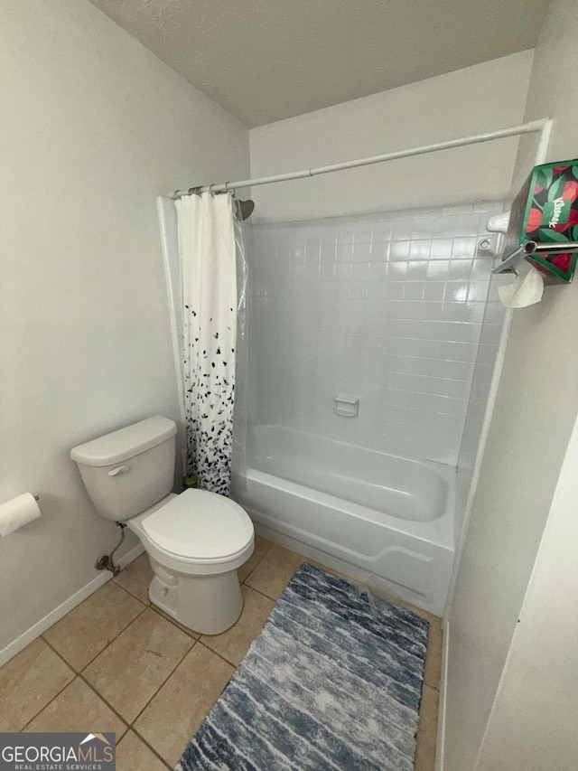 bathroom with tile patterned floors, shower / tub combo with curtain, and toilet