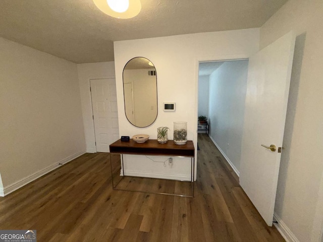 hallway featuring dark hardwood / wood-style flooring