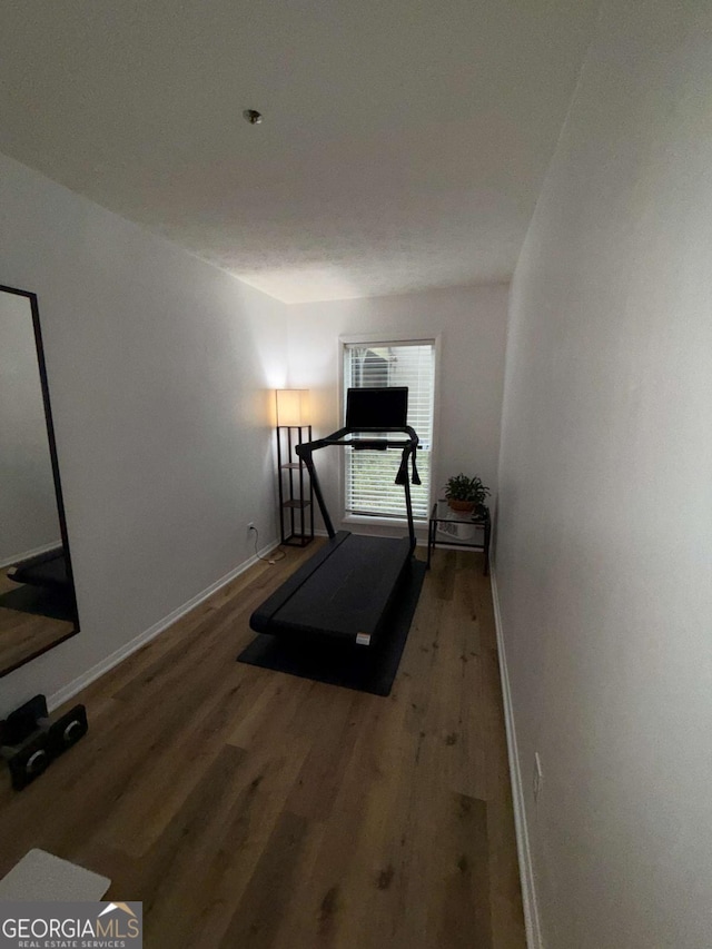 workout area with hardwood / wood-style floors