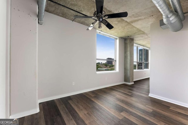 empty room featuring ceiling fan and dark hardwood / wood-style flooring