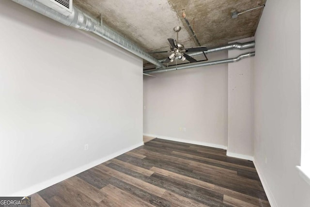 basement featuring ceiling fan and dark wood-type flooring