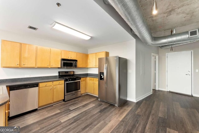 kitchen with appliances with stainless steel finishes, light brown cabinets, and dark wood-type flooring