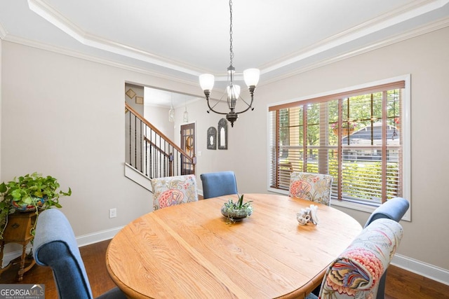 dining space featuring a tray ceiling, a wealth of natural light, and crown molding