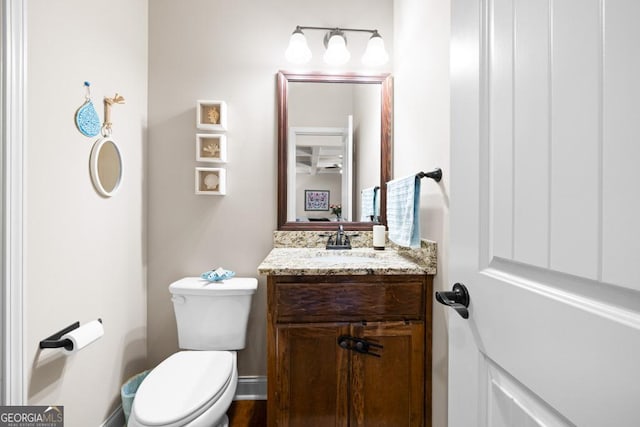 bathroom featuring vanity and toilet