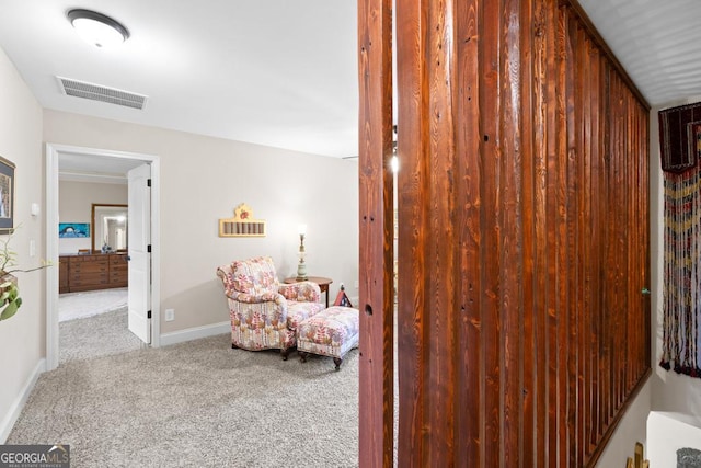 hall with light colored carpet