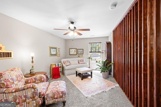 carpeted living room with ceiling fan