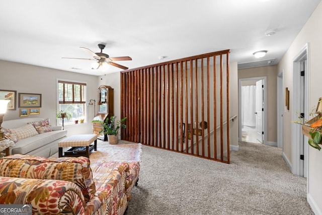 living room with ceiling fan and carpet