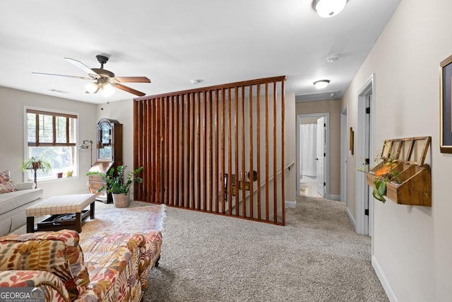 living room featuring ceiling fan and carpet