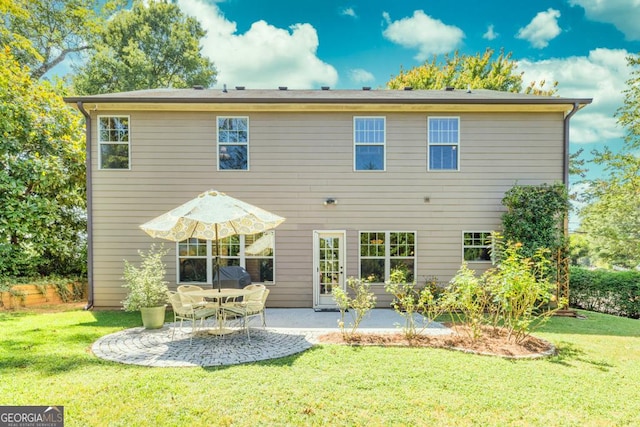 back of property with a lawn and a patio